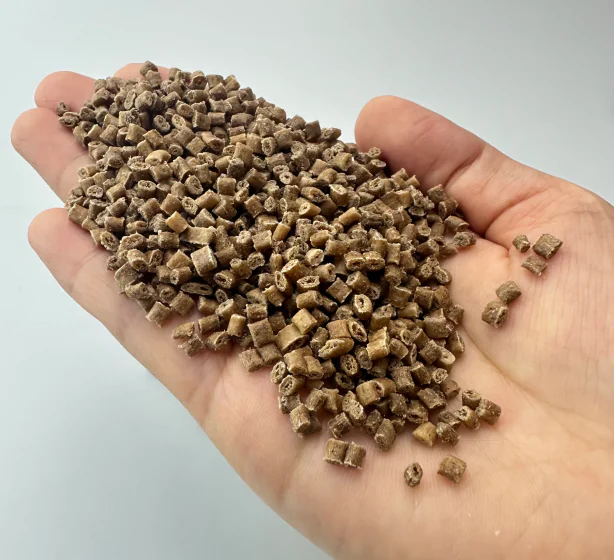 Wood fiber PA6 PA28 335M pellets held in hand