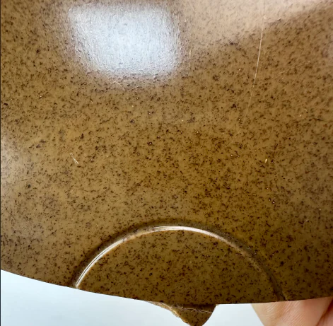 Close view of a wood fiber PA6 PA28 335M molded sample plaque