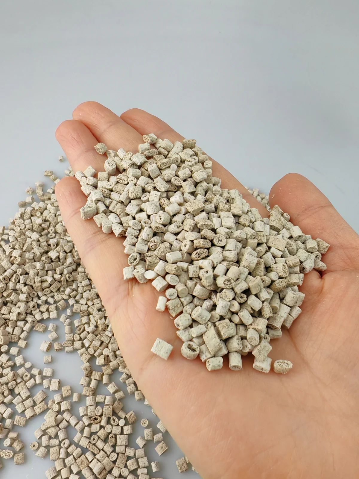 Bamboo fiber ABS pellets held in hand