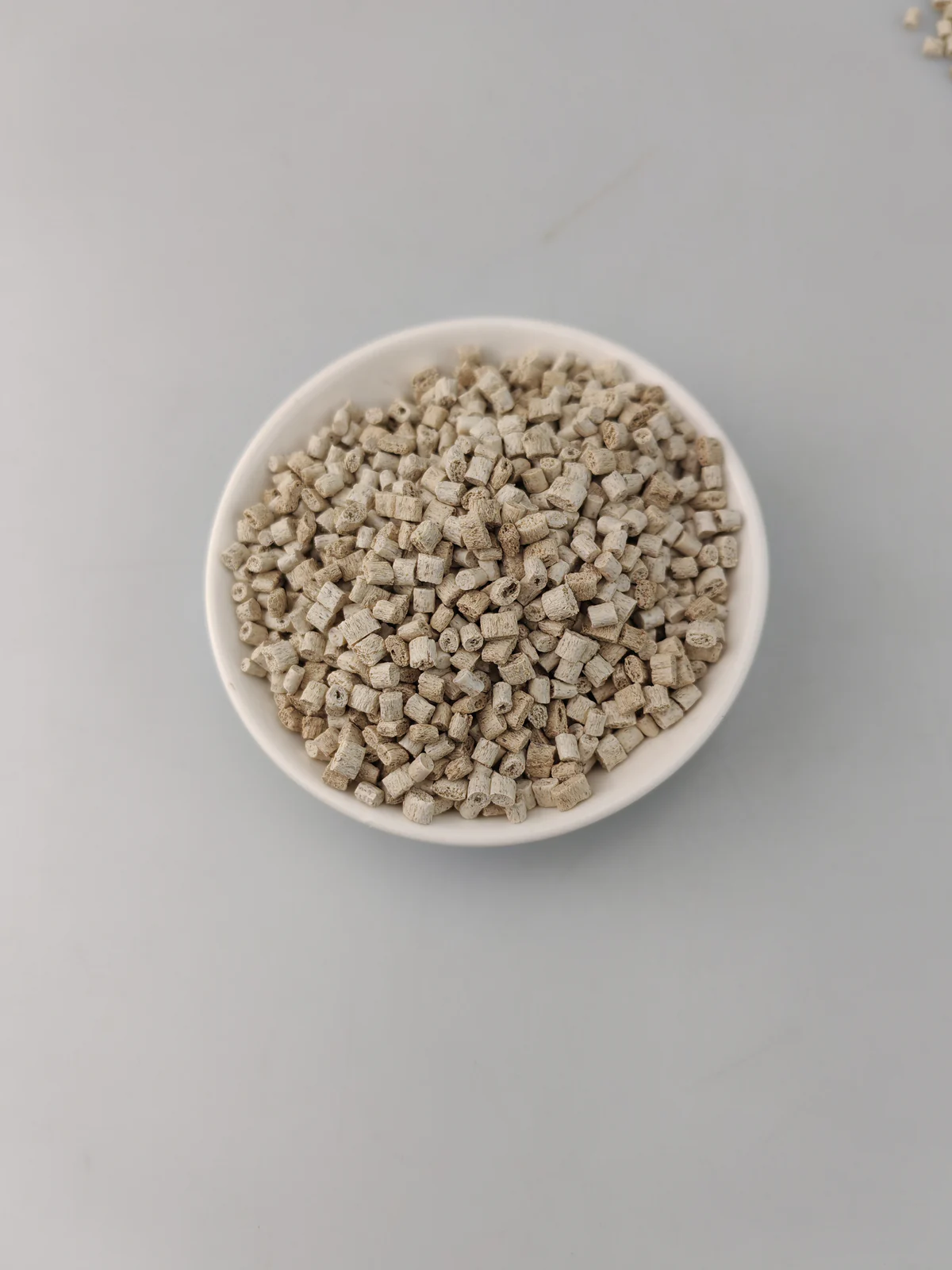 Bamboo fiber ABS pellets in a sample dish