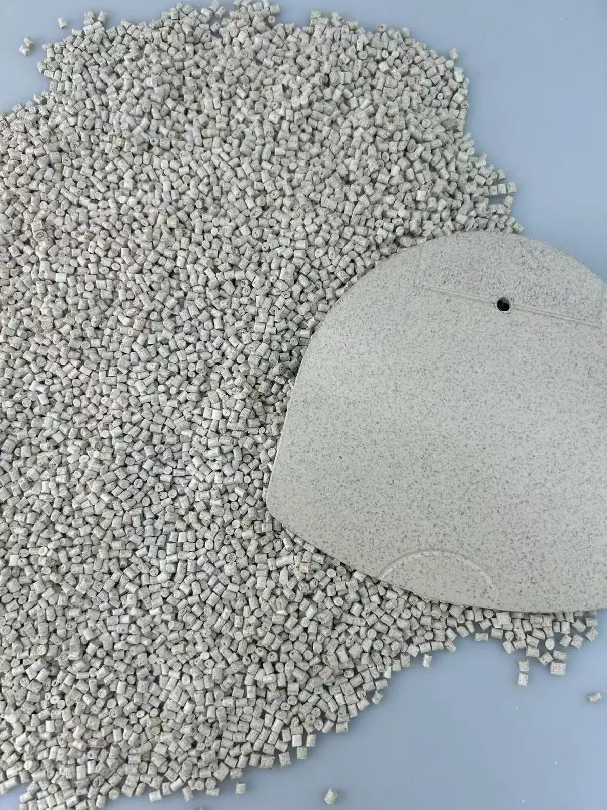 Cereal fiber ABS pellets with a single molded sample plaque